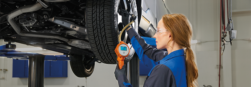 A Subaru technician checking tire pressure. | Bowser Subaru in Pittsburgh PA