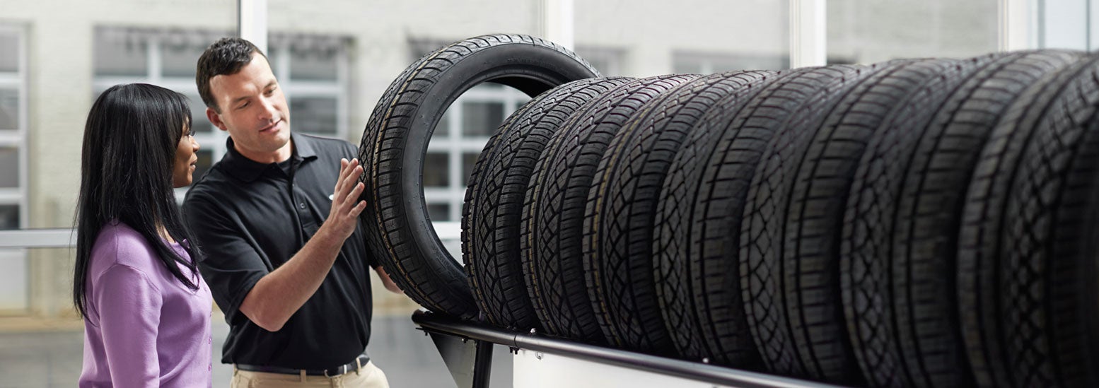 Subaru service representative showing customer a tire. | Bowser Subaru in Pittsburgh PA